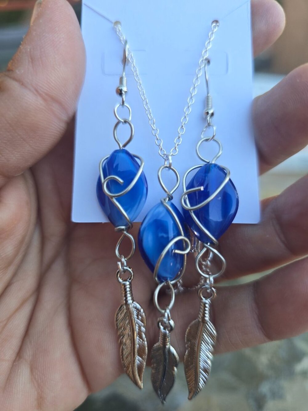 Royal blue beads with feathers and silver bead.